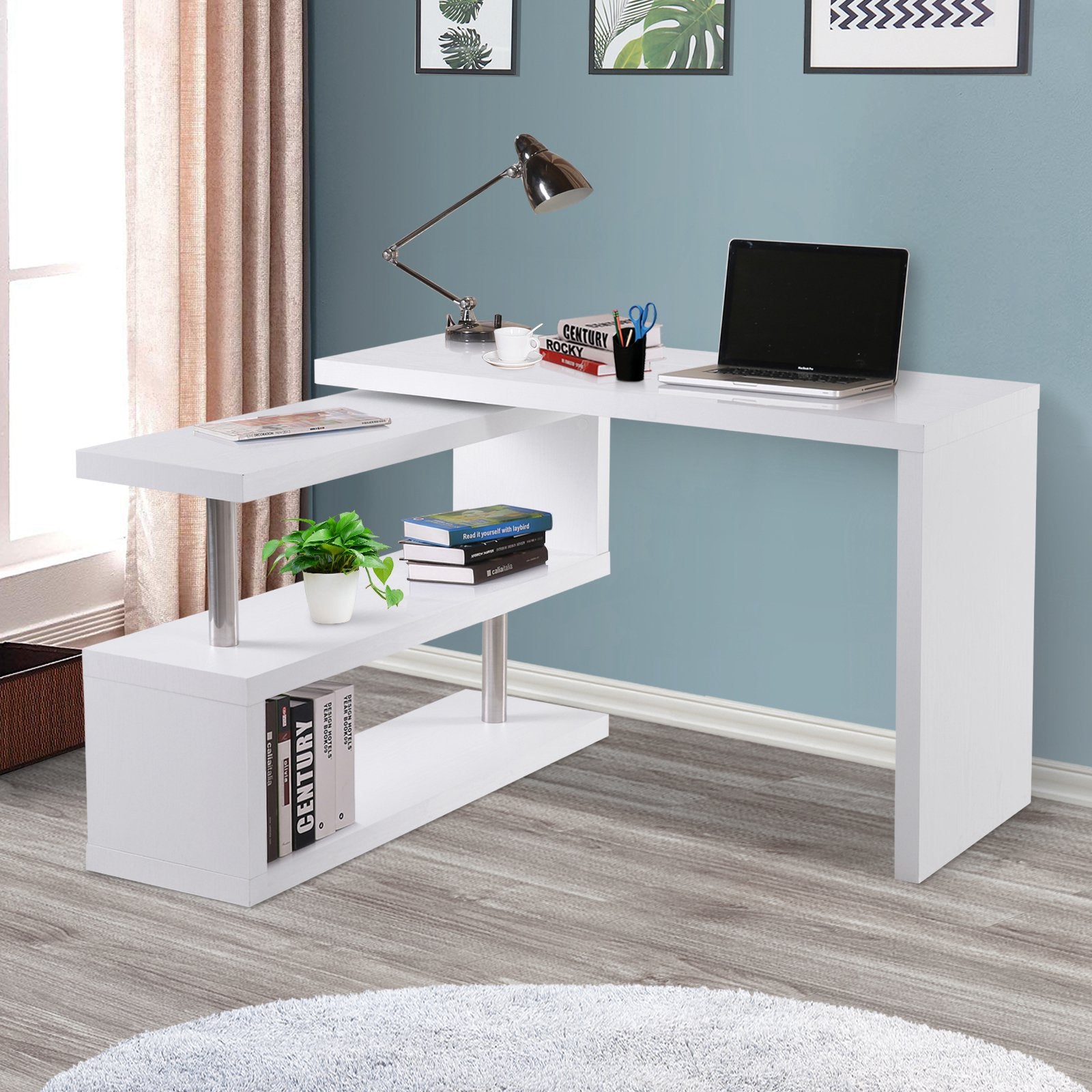 White L-shaped desk with a laptop, lamp, and books in a room with a window and curtains.