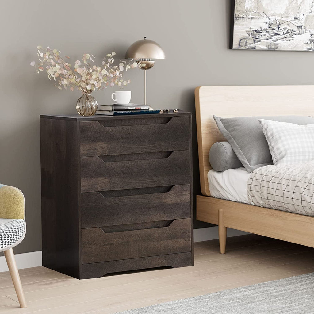 Wooden nightstand with decorative items next to a bed in a bedroom setting.