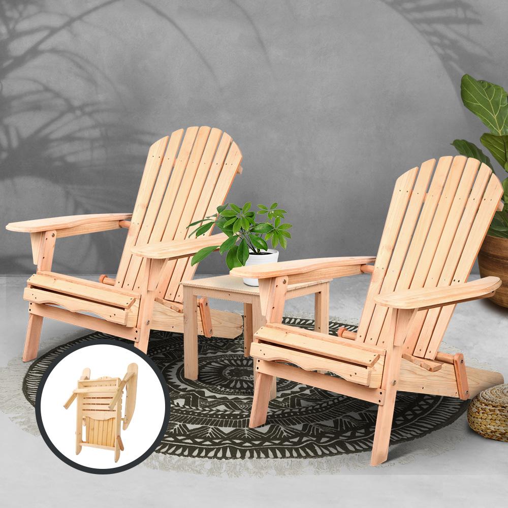 Two wooden Adirondack chairs with a small table and plant on a gray background.