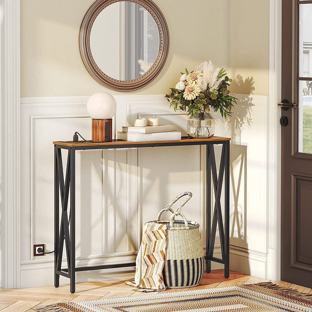 Console table with decorative items in a room with a door and mirror.