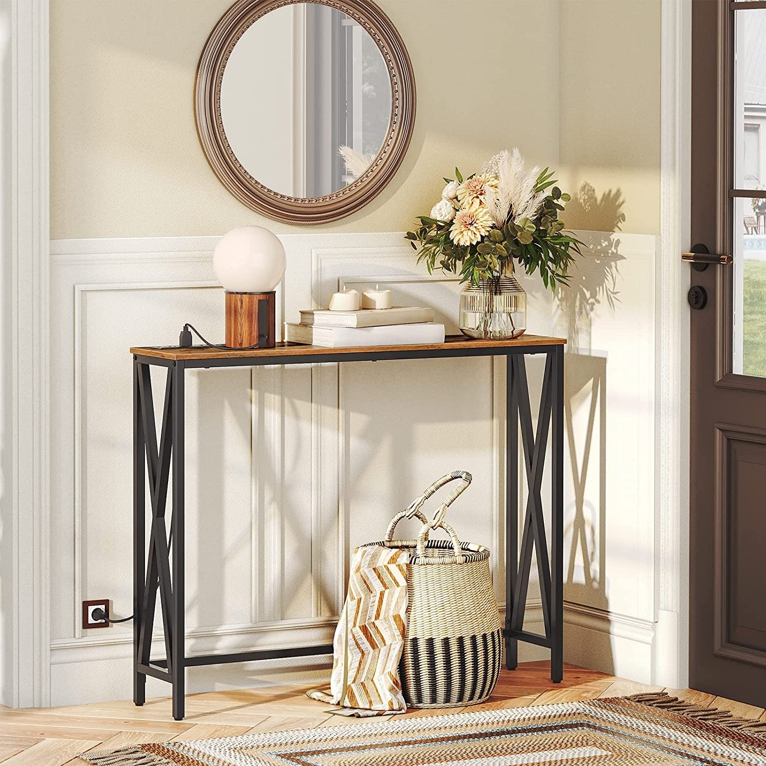 Console table with decorative items in a room with a door and mirror.